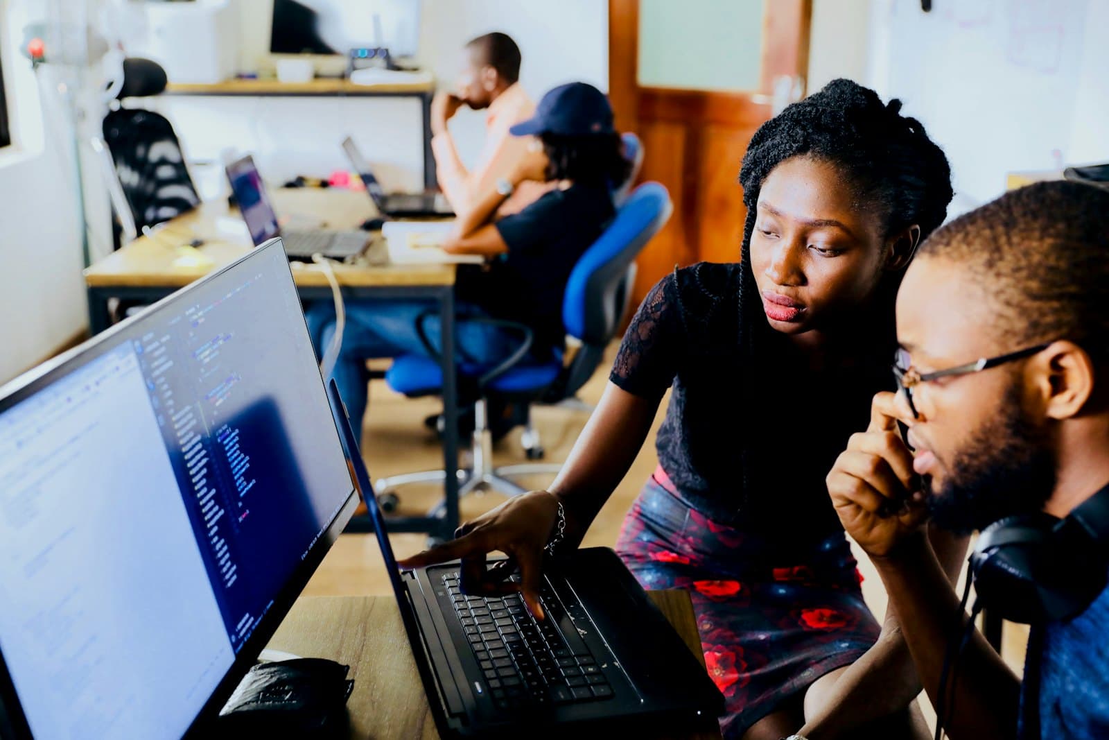Two engineers reviewing code together at a desk
