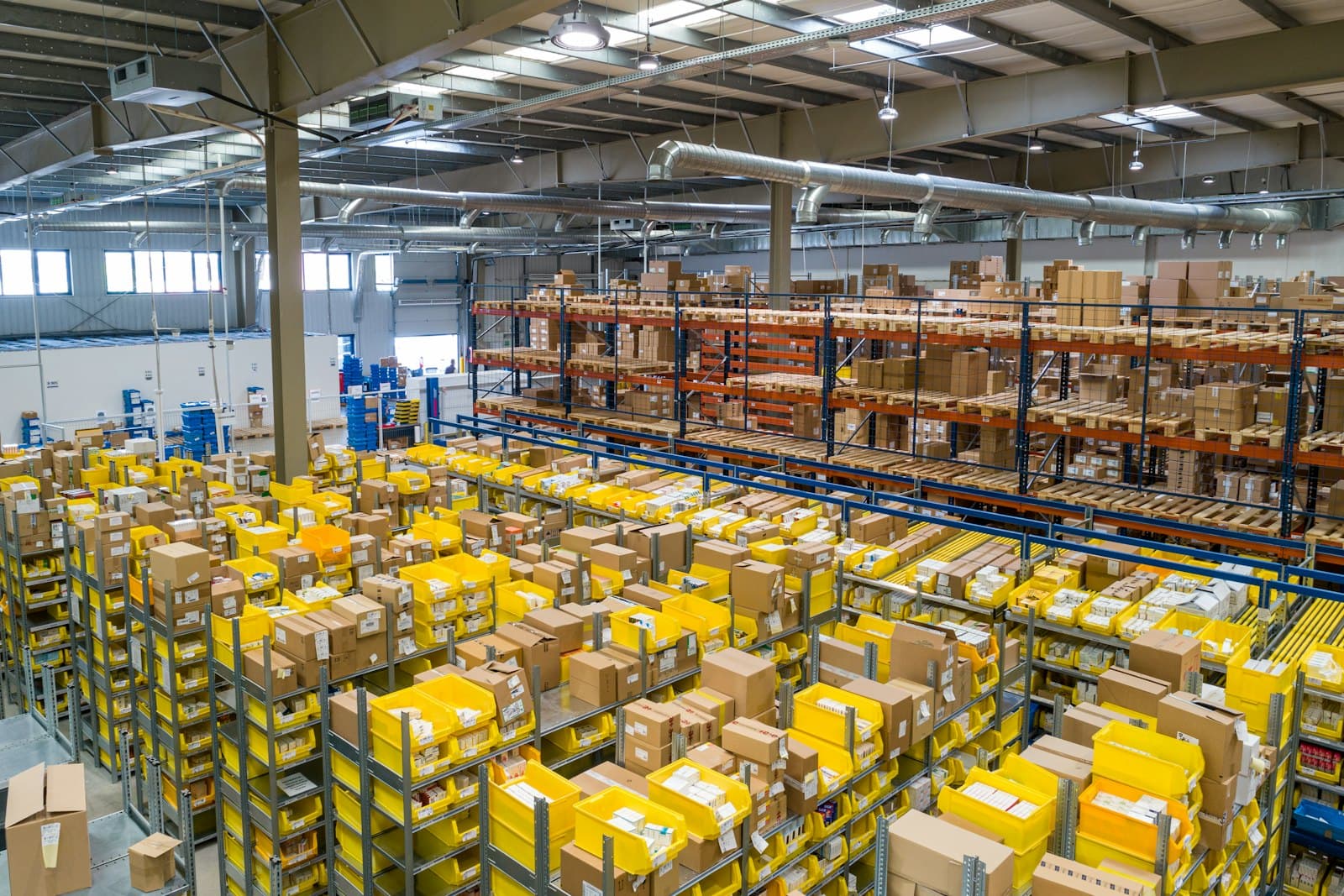 Organized warehouse aisles of inventory bins and boxes